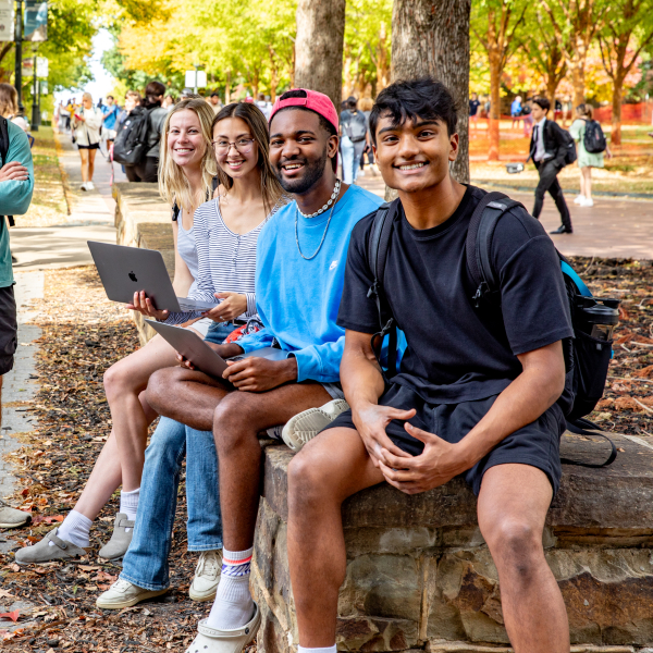 Uark students sitting on campus together